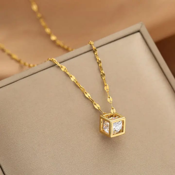 Elegant 3D cube pendant necklace in 18K gold plating showcasing a sparkling zircon crystal.