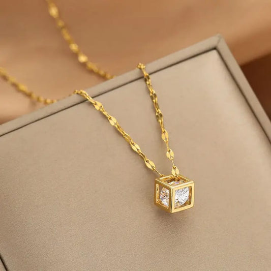 Elegant 3D cube pendant necklace in 18K gold plating showcasing a sparkling zircon crystal.